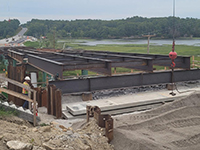 Hillside view of placed steel beams.